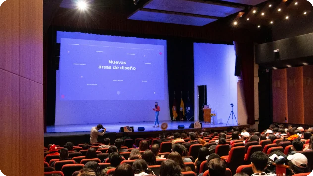 Gaby on stage in a full university auditorium