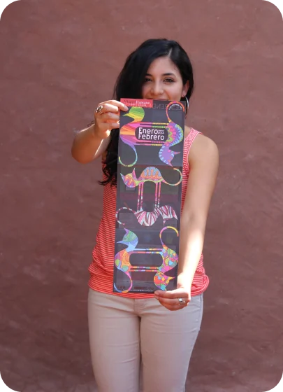 Gaby as a design student in Ecuador, holding one of her poster designs