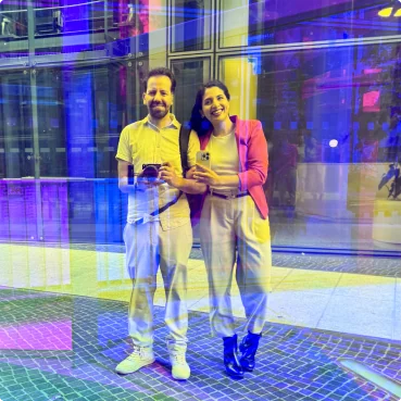 Gaby and her partner in a colourful light installation