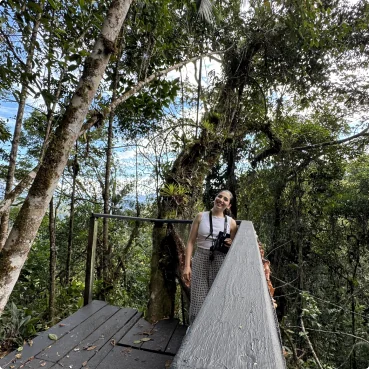 Gaby on a wooden canopy walkway in the forest