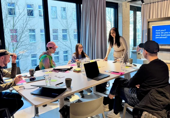 Participants working together around a table in a workshop